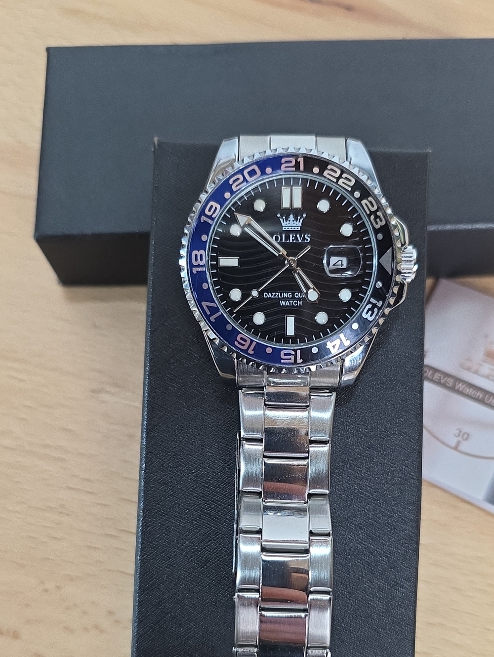 OLEVS Men's Silver Stainless Steel Watch with Black Dial and Blue Bezel